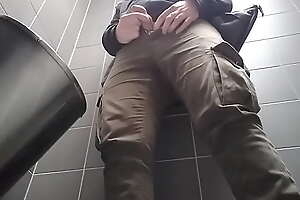 Young man with uncut dick peeing in a public urinal. He then shows and shakes his dick.
